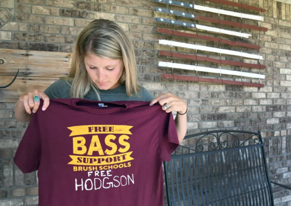 Mr. Bass' wife Tressa holds a Free Bass t-shirt